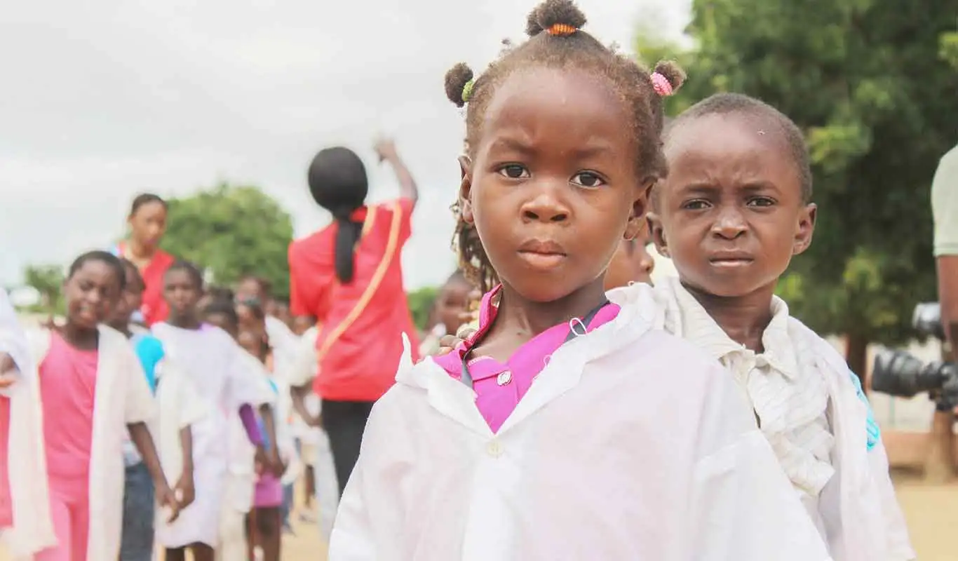 Niños de una comunidad vulnerable sonriendo, representando la esperanza y el futuro.